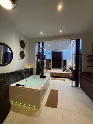 a living room with a hot tub in the middle at Charnel - Bora Bora in Liège