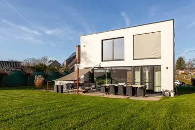 a white house with a lawn in front of it at 8P 4B Luxury Villa Close to Maastricht in Lanaken