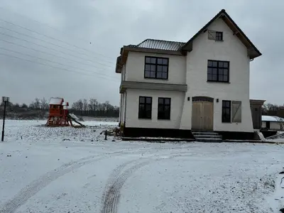 a house in a field with snow on the ground at Hidden Secret of Nature in Neeroeteren