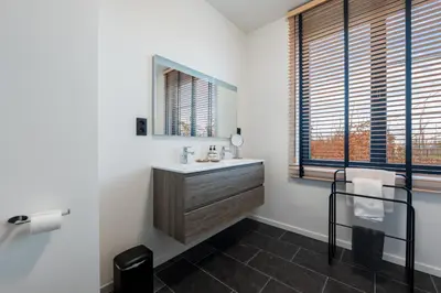 a bathroom with a sink and a mirror at Huys van Haeghe in Zoutleeuw