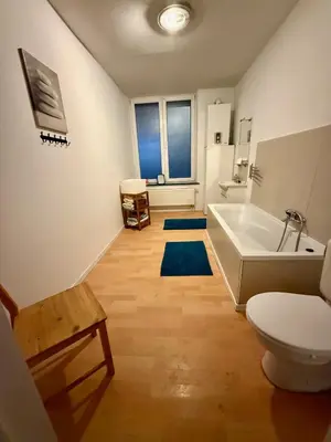 a bathroom with a tub and a toilet and a sink at Le Clémenty in Dison