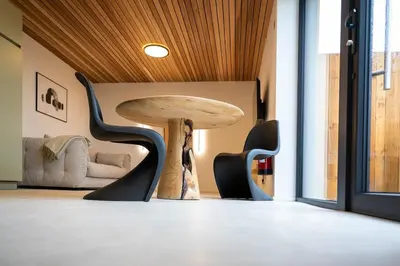 a table and chairs in a room with a table at Le Marzelheide 3 in Lontzen