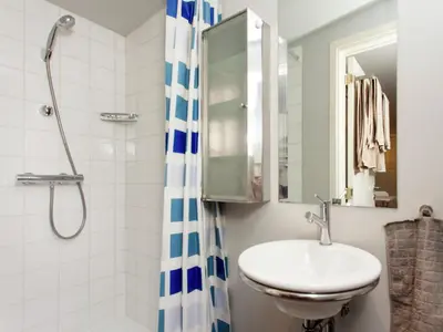 a bathroom with a sink and a shower at Fishing Chalet, Opglabbeek in Oudsbergen