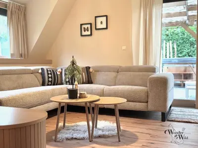 a living room with a couch and two tables at Wonderwild E87, Connect to nature & Dog Friendly in Lanaken