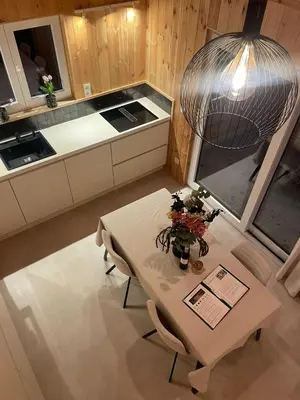 a kitchen with a table with flowers on it at Lysdann Zutendaal in Zutendaal