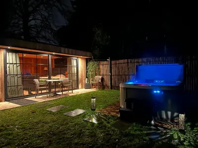 a backyard at night with a pool in the grass at maison Clavita in Genk