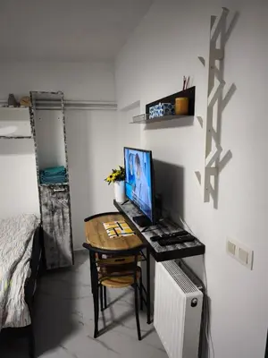 a desk with a computer on it in a bedroom at Modern lux studio B in Beringen