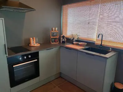 a kitchen with a sink and a stove at Your wellness break in Dalhem