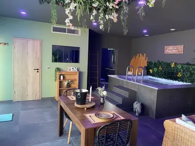 a kitchen with a sink and a table and a tub at Your wellness break in Dalhem