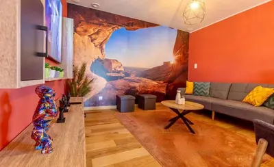 a living room with a large painting on the wall at Charming 2-Bedroom House Rental in Dalhem, Belgium in Dalhem