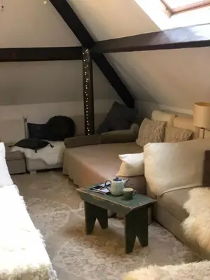 a living room with a couch and a table at Villa des Bois Sauvages in Liège