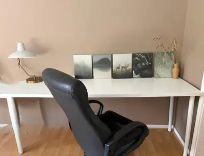 a black chair sitting in front of a white desk at Villa des Bois Sauvages in Liège