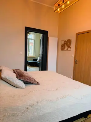 a bedroom with a bed with two pillows on it at Appartement Premium à Liège in Liège