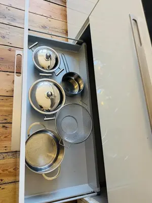 a drawer full of pots and pans in a kitchen at Appartement Premium à Liège in Liège