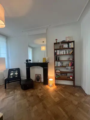 a living room with a fireplace and a book shelf at House with garden for 4 people in Verviers