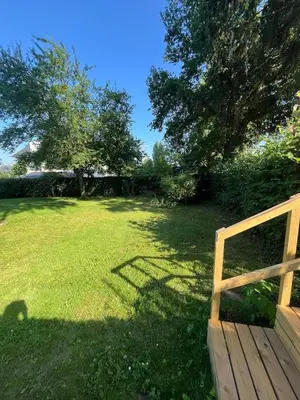 a wooden fence in a yard with a field of grass at House with garden for 4 people in Verviers