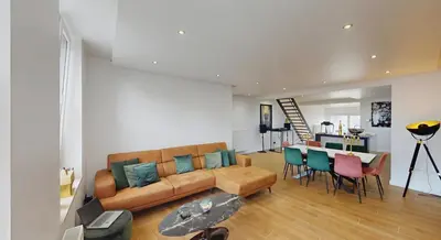 a living room with a couch and a table at Home cinema in Liège