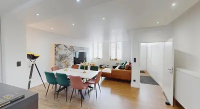 a living room with a table and chairs and a couch at Home cinema in Liège