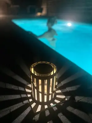 a person swimming in a pool with a basket in the shadows at Wellness L'eau Belle in Beringen