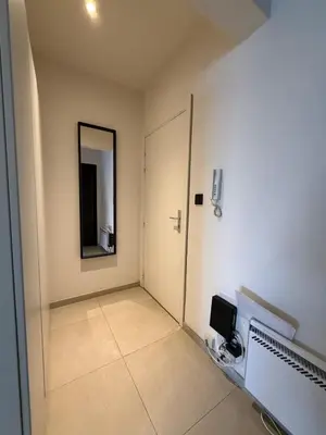 a room with a door and a mirror on the wall at Charming studio in the heart of Liege - total comfort in Liège