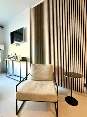 a chair and a table in a room at Charming studio in the heart of Liege - total comfort in Liège