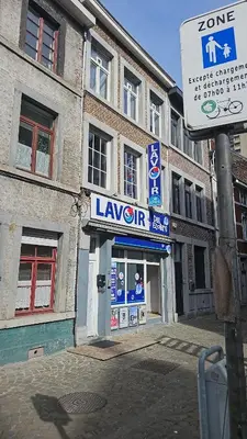 a sign in front of a large building at Logement Sam in Liège