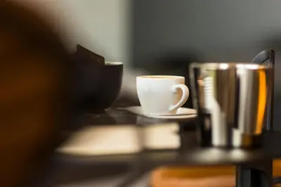 a cup of coffee sitting on a table next to a mug at Loft La Suite et sa Suite in Thimister