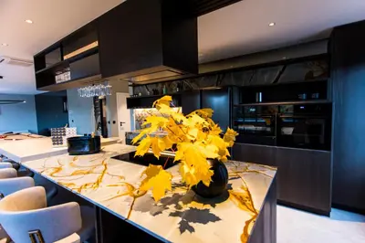 a kitchen with a table with yellow leaves on it at Loft La Suite et sa Suite in Thimister