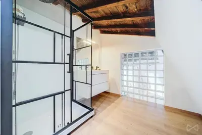 a glass door in a room with a wooden ceiling at Logement temporaire haut de gamme Particuliers & entreprises in Liège