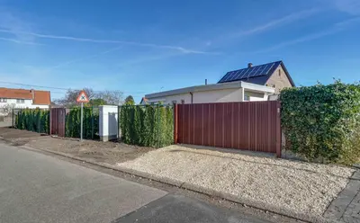 a red fence in front of a house at 't Vennehuys in Genk