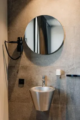 a bathroom with a silver sink and a mirror at Coliving - Bord de Meuse - L'écrin Vert in Oupeye