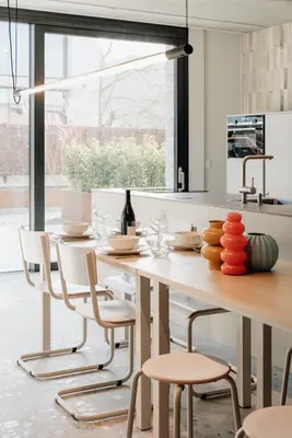 a kitchen with a large white table and chairs at Coliving - Bord de Meuse - L'atelier de la Meuse in Oupeye