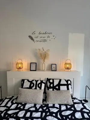 a bedroom with a bed with two lights on the wall at Charming Apartment in Lontzen on 72 m² in Lontzen