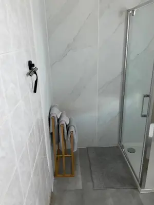 a bathroom with a shower and a rack of towels at Charming Apartment in Lontzen on 72 m² in Lontzen