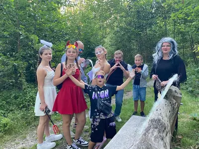 a group of people dressed in costumes standing on a bridge at Camping San Lanaco in Lanaken