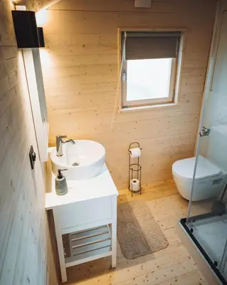 a bathroom with a sink and a toilet at Camping Papillon Kinrooi - Pipowagen met terras in Kinrooi