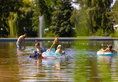 a group of people floating on tubes in the water at Camping Papillon Kinrooi - Pipowagen 2p in Kinrooi