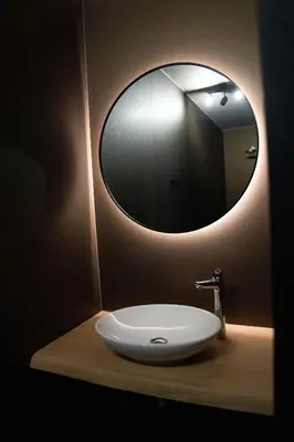 a bathroom sink with a large mirror on the wall at Camping Natuurlijk Limburg - Studio 1 in Voeren