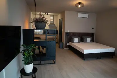 a bedroom with a bed in a room at Camping Natuurlijk Limburg - Studio 1 in Voeren