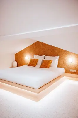 a bedroom with a large white bed with two pillows at Héritage Collection - Suites in Verviers