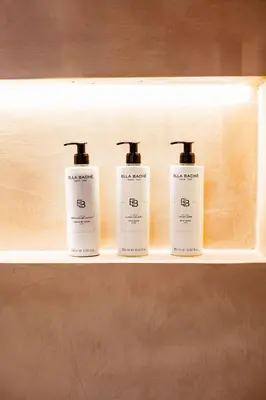 three bottles of soap sitting on a shelf at Héritage Collection - Suites in Verviers