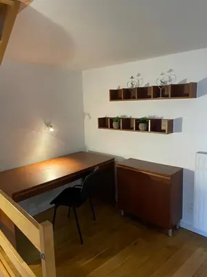 a desk and a chair in a room at Le Havre de paix in Oupeye