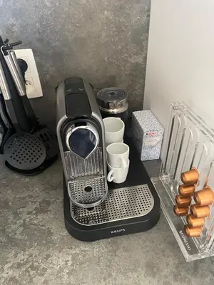 a toaster sitting on top of a counter with cups at Le Havre de paix in Oupeye