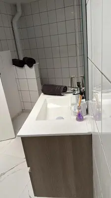 a bathroom with a white sink and a mirror at Studio Cosy rénové au Centre de Liège in Liège