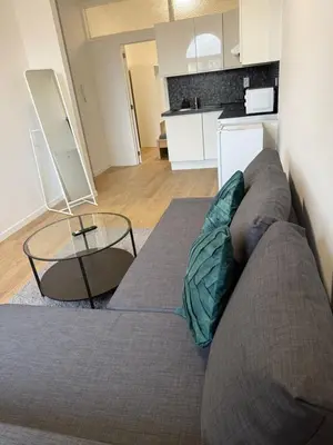 a living room with a couch and a glass table at Appartement fraîchement rénové de 1 chambre et Sofa Bed en plein Cœur de Liege in Liège