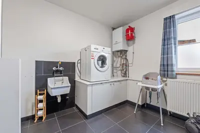 a laundry room with a washing machine and a sink at Ruime vakantievilla in Halen voor 12 personen in Halen