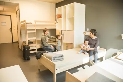 a group of people in a room with bunk beds at Hostel H in Hasselt