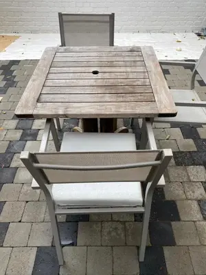 a wooden picnic table with a chair and a bench at Studio Peralta in Liège