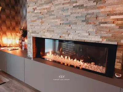 a fireplace in a room with a brick wall at La Suite in La Calamine