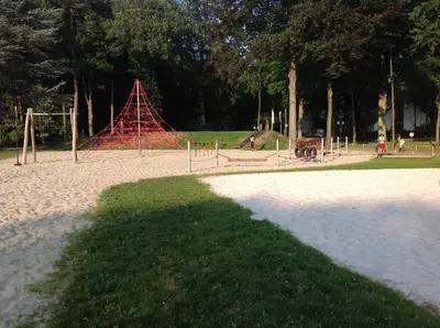 a playground with a red structure in a park at Domein Hengelhoef in Houthalen-Helchteren